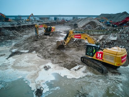 Große Baumaschinen in schlammiger Umgebung